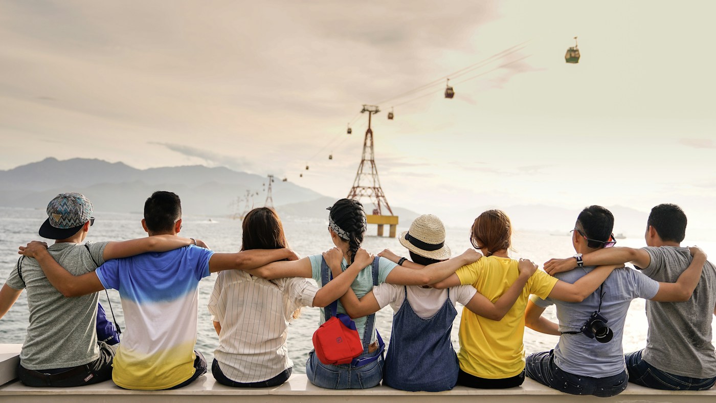 Community members sitting together by the sea